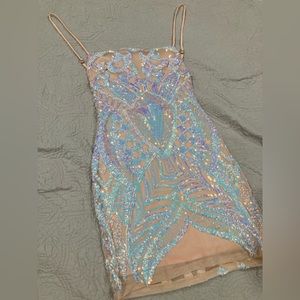 Small, tan dress with rainbow sequence mermaid design, open back, square neck.